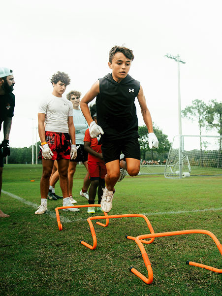 Young players training with hurdles